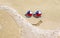 Sunglasses with flag of Chile on a sandy beach. Nearby is a sea lightning and a painted smile.