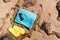 Sunglasses, flip flops, blue towel ready for sunbathing on a sunny afternoon. at beach