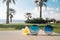 Sunglasses and flowers on a beach lounge chair . Tropical summer vacation concept. Happy sunny day on the beach of tropical island