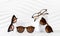 Sunglasses and glasses sale concept. Trendy sunglasses on podiums on white background. Trendy Fashion summer accessories. Copy