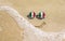 Sunglasses with Italian flags on a sandy beach. Nearby is a sea lightning and a painted smile.