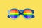 Sunglasses LGBTQ community flag colors yellow background close up, rainbow pattern glasses, LGBT pride people symbol, gay, lesbian