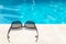 Sunglasses near the edge of a swimming pool