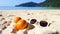 Sunglasses and orange fruits on white sand beach.