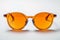 Sunglasses with orange glass in stylish iron frame isolated white