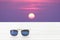 Sunglasses place on wooden with sunrise scape.