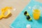 Sunglasses, sand toys and juice on beach towel