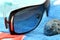 Sunglasses and seashell on a beach towel