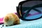 Sunglasses and seashell on a beach towel