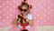 Sunglasses in the shape of heart. A little girl lady dresses up - red bag and shoes. Funny child. Pink background