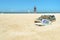 Sunglasses and shoes on the beach with people on background