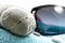 Sunglasses and stones on beach towel