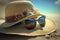 Sunglasses, straw hat and beach towel on sand