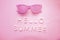 Sunglasses and text hello summer. Top view. Holidays and vacation concept monochrome pink colored photo