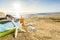 Sunglasses, towels, hat, sun block, shells and starfish on sandy