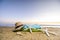 Sunglasses, towels, hat, sun block, shells and starfish on sandy