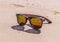 Sunglasses on wet sand, beach
