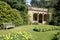 Sunken garden with an old summerhouse and a bench