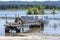 Sunken old rusty semi trailer and an unloaded stacked cargo standing in water after a Columbia River flood causes environmental