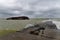 Sunken old ship tanker on the seashore and old concrete pier. dramatic sky and stormy sea.