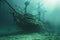 Sunken shipwreck underwater with fish swimming around
