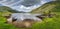 Sunken and submerged paddle boats in Lough Gummeenduff with view on beautiful Black Valley