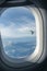 Sunlight and airplane wing view at porthole