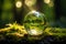 Sunlight bathes an earth sphere crystal on green moss background
