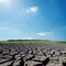 Sunlight in blue sky over drought earth