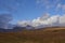 Sunlight breaking through the low cloud on to the rolling hills of Rannoch Moor.