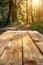 Sunlight Filtering Through Forest onto Rustic Wooden Table in Natural Outdoor Setting
