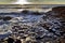 Sunlight highlighting the hexagonal Basalt slabs of Giants Causeway