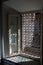 Sunlight through ornate metal window grill