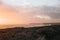 Sunlight over the greenery on Seven Sisters chalk cliffs in East Sussex, UK