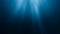 Sunlight rays shining through ocean surface. View from underwater. 3D rendered seamless loop animation