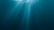 Sunlight rays shining through ocean surface. View from underwater. 3D rendered seamless loop animation