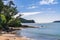 Sunlight sparkling on calm water surface at a small sheltered sand beach. Gorgeous summer day in Paihia, Bay of Islands