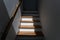 Sunlight on staircase wooden with wooden handrails on white wall in modern home. Interior structure design concept. Empty pathway