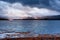 Sunlight through storm clouds over a Scottish Loch