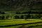 Sunlight streaks across the Langdale Valley in the English Lake District