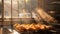 Sunlight streaming through a kitchen window illuminating a tray of golden pastries cooling on a wire rack