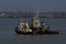 Sunlight on tugs during brief break in clouds