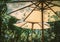 Sunlight through white parasol. garden furniture