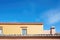 sunlit adobe walls with blue sky backdrop