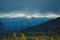 Sunlit alpine mountain range with snow tops during stormy weather in Inntal, Tirol, Austria