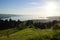 sunlit alpine view from Eichenberg in Austrian Alps and German side of lake Constance with island of Lindau in the evening sun