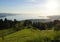 sunlit alpine view from Eichenberg in Austrian Alps and German side of lake Constance with island of Lindau in the evening sun