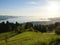 sunlit alpine view from Eichenberg in Austrian Alps and German side of lake Constance with island of Lindau in the evening sun