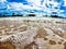 Sunlit Beach, Serene Waves, and Docked Boats