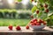 Sunlit bowl of fresh strawberries on outside table